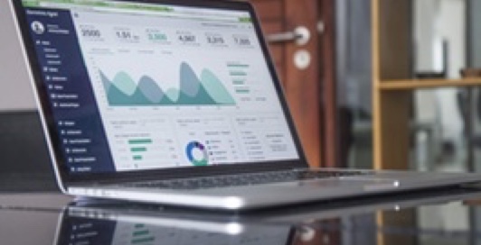 Open laptop with data charts on the screen